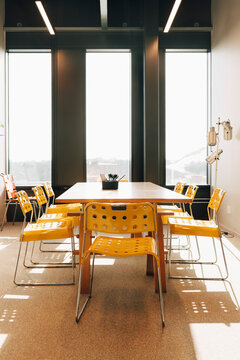 Modern conference room setup with yellow chairs and table