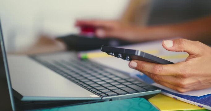 Person Using Smartphone and Laptop Indoors