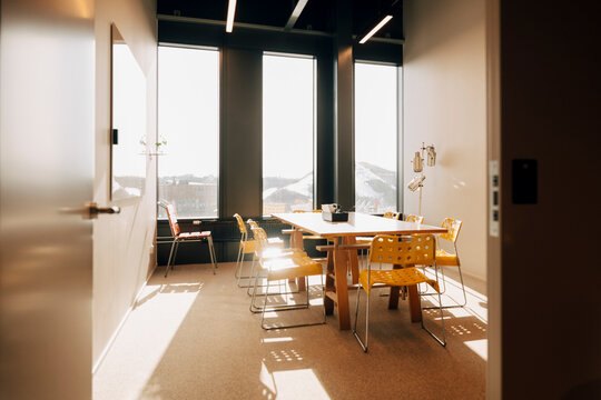 Interior of sunlit office room ready for business team meeting