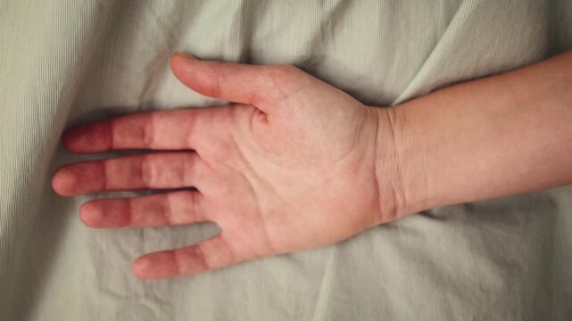 A woman is making a gesture indicating domestic violence. Palm of hand is behind her back demostres distress signal. High quality 4k footage