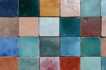 Fototapeta premium Colorful square ceramic tiles arranged in a grid pattern, showcasing diverse earthy and oceanic hues