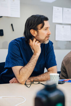 Male doctor spending leisure time in hospital cafeteria