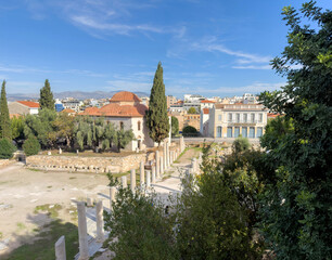 Obraz premium Ancient Agora in Athens, Greece, elevated view. Marble columns, archaeological ruins and a Byzantine church, blue sky