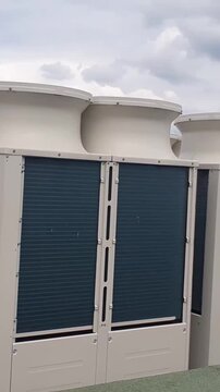 Panning shot of exterior VRV air conditioning condenser units, highlighting HVAC ventilation, extraction, and eco-friendly heating and cooling systems.