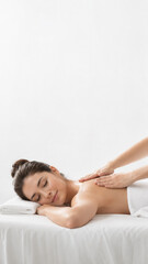 Obraz premium Serene Relaxation: A person undergoes a massage therapy session, with hands gently kneading the back. It's a scene of tranquil rejuvenation.