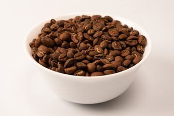 Fototapeta premium Coffee beans on a white background. Top view. Coffee beans texture.