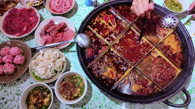Tourists eating the original spicy dish mala spicy hot pot in Chengdu, China