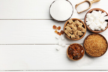 Different types of sugar on white wooden table, flat lay. Space for text © New Africa
