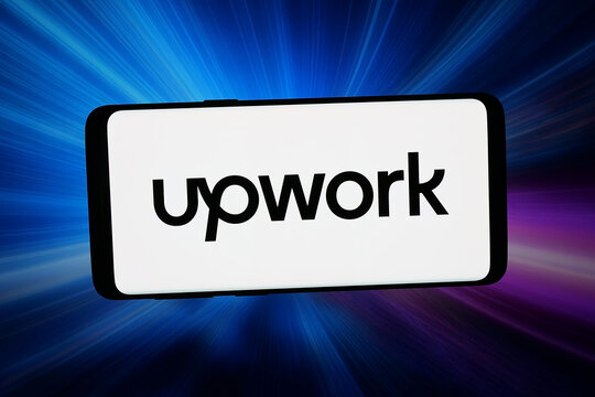 Stuttgart, Germany - 04-27-2026: In this photo illustration, the logo of freelancing company Upwork Global Inc. is displayed on a smartphone in front of abstract background on computer screen.