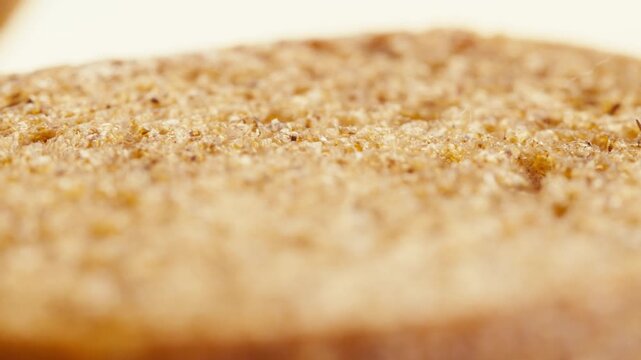 Black rye bread close up, dark brown sliced loaf, borodinsky slavic food, square slices with coriander on white background