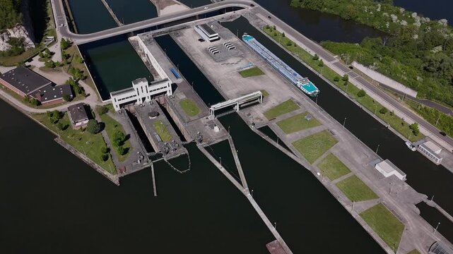 Lock on River Maas near Maastricht shows a barge moving through Ecluse de Lanaye at the border of Belgium and the Netherlands