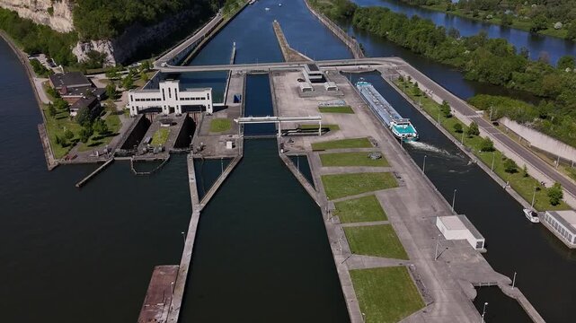 Barge passing through Ecluse de Lanaye lock on River Maas near Maastricht