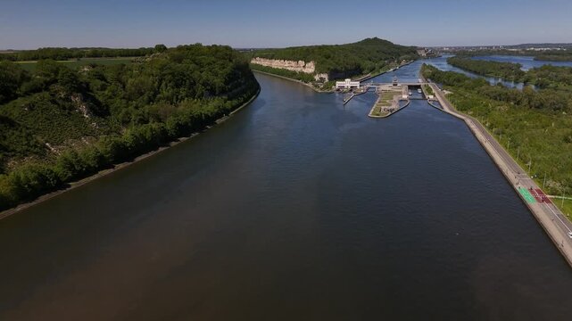 Lock on River Maas near Maastricht shows barge passing through Ecluse de Lanaye in Belgium and Netherlands border area