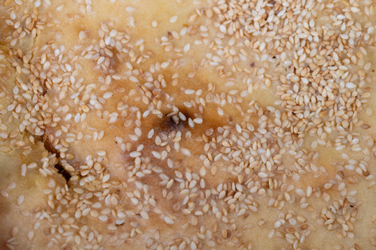 Detailed pastry surface. Precise sesame seed placement on baked bread mockup surface. Realistic sesame covered pastry surface ideal for packaging and branding presentations