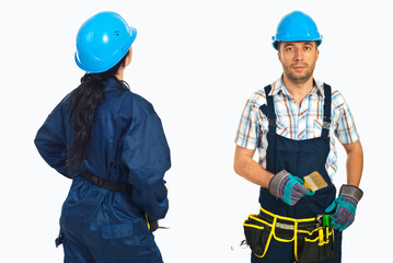 Fototapeta premium Blue helmeted worker stands with tools in hand