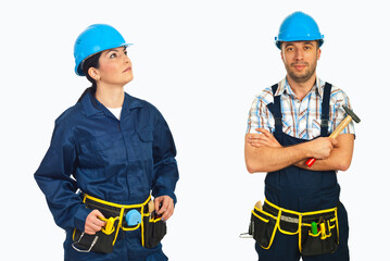 Fototapeta premium Two workers wear hard hats and tool belts