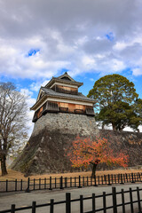 Fototapeta premium The fortress or rampart standing high in ancient castle of japan, with blue sky.