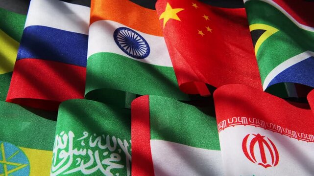 A close up of the national flags of the 11 full members of the BRICS alliance.