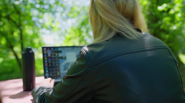 Modern Female Professional Working on Laptop Outdoors: Concept of Remote Work, Female Entrepreneurship, and Digital Connectivity in Nature
