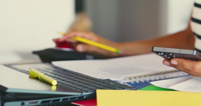 Hands Typing and Writing in Office Workspace
