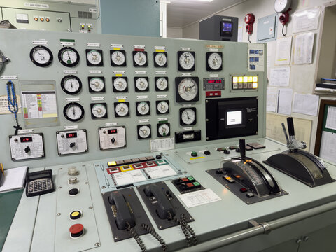 ship engine control panel. central control console at engine control room. telegraph, communication, manometers, tachometers, prevention pollution control equipment.