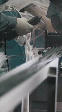 Manufacture of composite fiberglass reinforcement - worker cuts wires and counting production