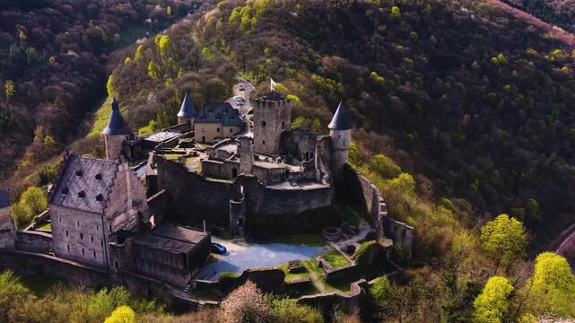 A panoramic Aerial view of the city and castle Bourscheid in Luxembourg, on a sunny spring noon