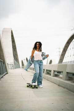 young woman on the walkway with skate