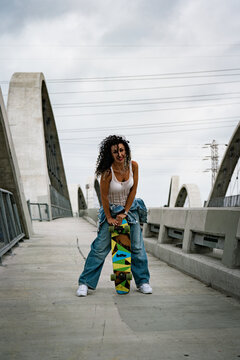 young woman on the walkway with skate