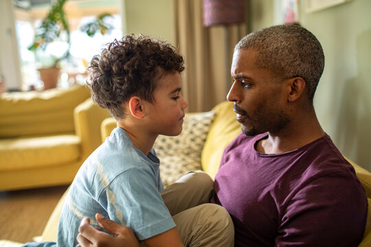 Father and son having serious talk at home