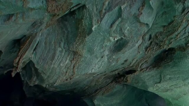 Discovering the breathtaking Marble Caves in Patagonia. Sunlit emerald waters reflect on sculptured marble walls, revealing nature's intricate artistry inside these ancient grottoes.