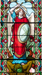 Naklejka premium Stained glass (19th century) of Saint Michel the Archangel killing a demon.