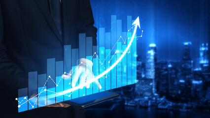 Businessman stands with a digital tablet displaying a virtual growth chart over a city skyline, representing financial success and data-driven innovation. Scalp © InfiniteFlow