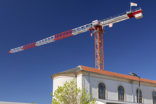 Nancy, France - April 25th 2026 : View on a flat-top tower crane Liebherr 250 EC-B 12 Litronic on a construction site for the construction of a building with the blue sky.