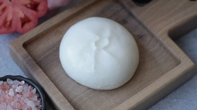 Fresh white burrata cheese with tomatoes for a salad. Burrata cheese as a food background for your design