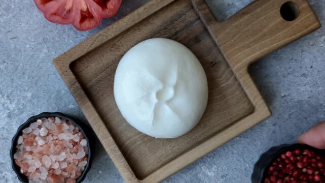 Fresh white burrata cheese with tomatoes for a salad. Burrata cheese as a food background for your design