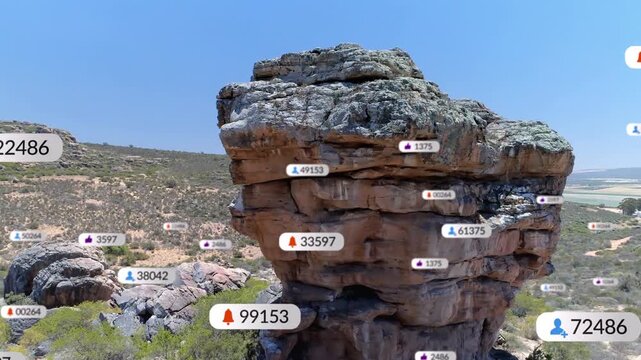 Aerial camera approaching sandstone rock formation showing growing badges displaying social metrics