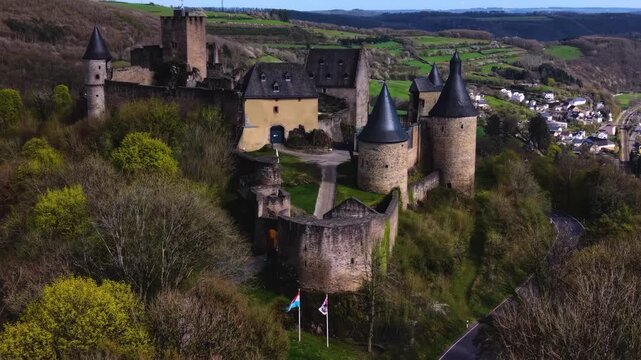 A panoramic Aerial view of the city and castle  Bourscheid in Luxembourg, on a sunny spring noon