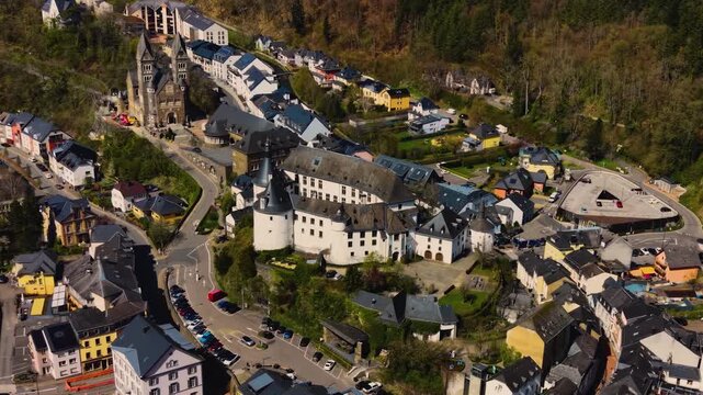 A panoramic Aerial view of the city and castle Clervaux in Luxembourg, on a sunny spring noon