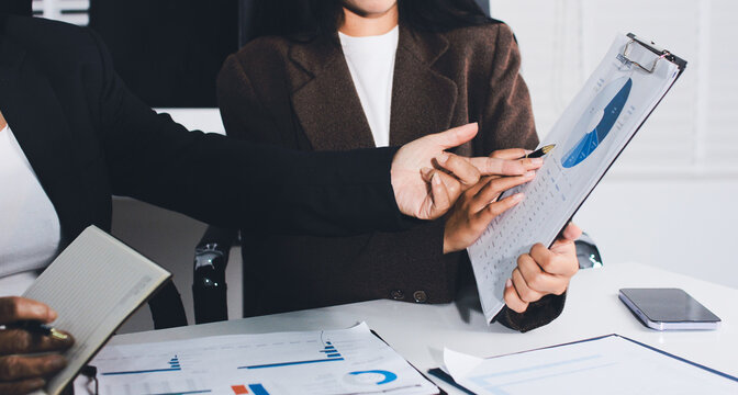 Accountants processing financial documents and taxes, managing corporate finance in a modern office. Audit and taxes in business