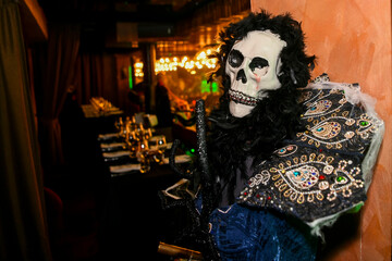 Fototapeta premium The atmospheric photography from the Halloween-themed event features a dramatic Halloween-inspired set, framed by spooky costumes, faux spider webs and mystical red lighting.