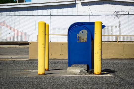 Old worn mailbox in parking lot