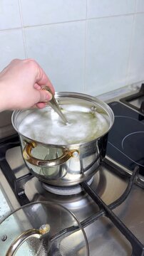 Chef cooking gooseneck barnacles in boiling water