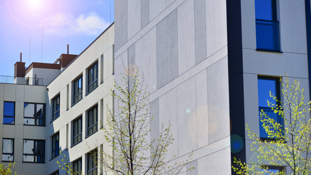 European residential architecture harmonizing with nature. Eco-friendly living in city with greens. Eco apartment building saving energy and fresh air concept. 