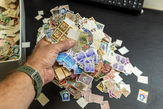 a hand full of old used stamps