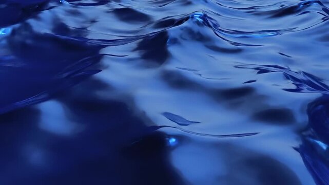 Deep blue water surface rippling with dark abstract wave pattern in seamless loop