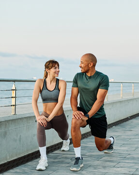 Portrait os a happy beautiful couple exercising and stretching outdoors