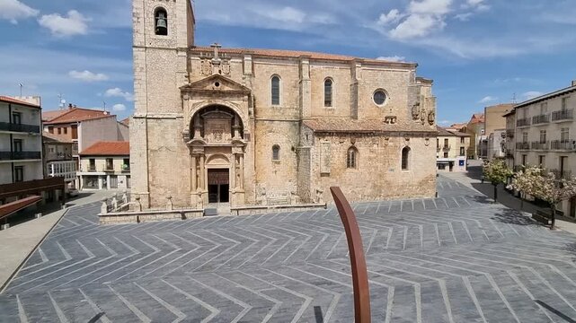The ornate Renaissance portal of the Church of Nuestra Se&ntilde;ora de la Asunci&oacute;n in Roa de Duero, Burgos, Spain. A historic architectural landmark featuring detailed stone carvings and a bell tower.
