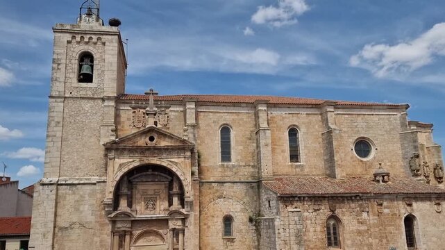The ornate Renaissance portal of the Church of Nuestra Se&ntilde;ora de la Asunci&oacute;n in Roa de Duero, Burgos, Spain. A historic architectural landmark featuring detailed stone carvings and a bell tower.