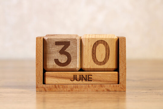 June 30 wooden block calendar on desk concept of end of month deadline pressure and final day schedule